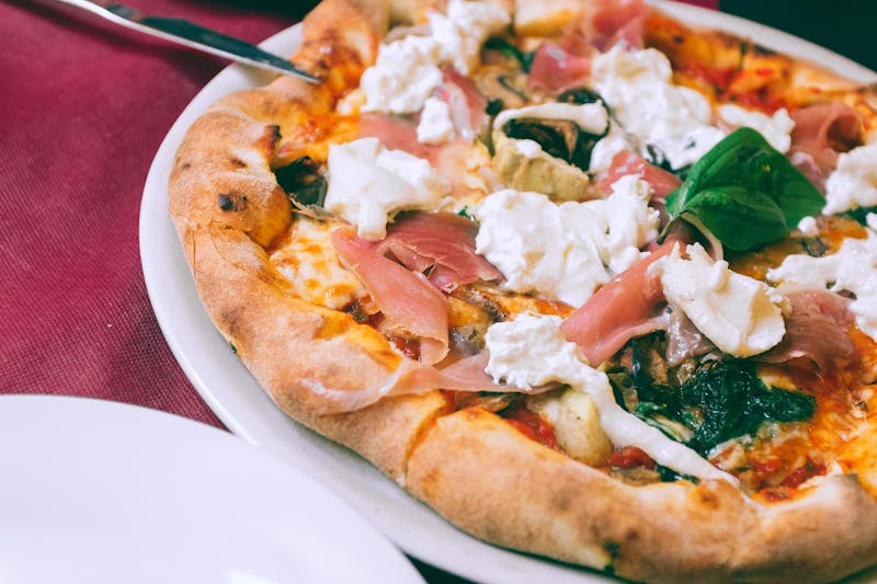 Prosciutto and rocket gourmet pizza with parmesan